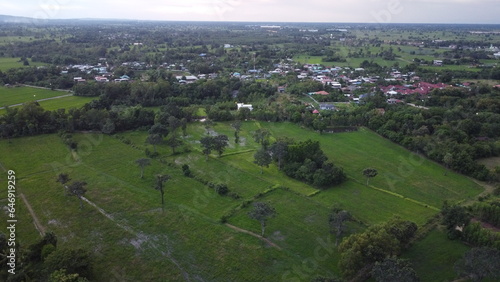 Aerial view of green fields and farmlands in rural Thailand.