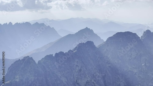 Pano 4K aerial footage of misty early morning High Tatras mountain range with incredible light and shadows play. Rysy peak 2499m view.
