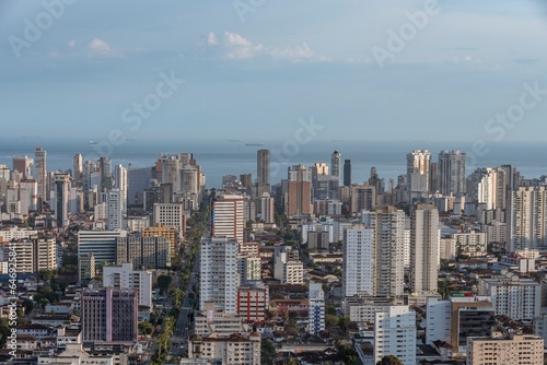 City of Santos, Brazil. Aerial view of the city. Ana Costa avenue on the right crossing the neighborhoods of Vila Mathias, Campo Grande and Gonzaga. In the background the sea and ships on the horizon. photo