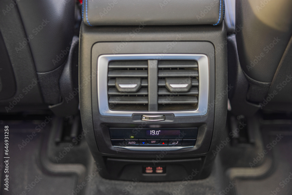 Close-up view of rear dual-zone climate control of new car. 