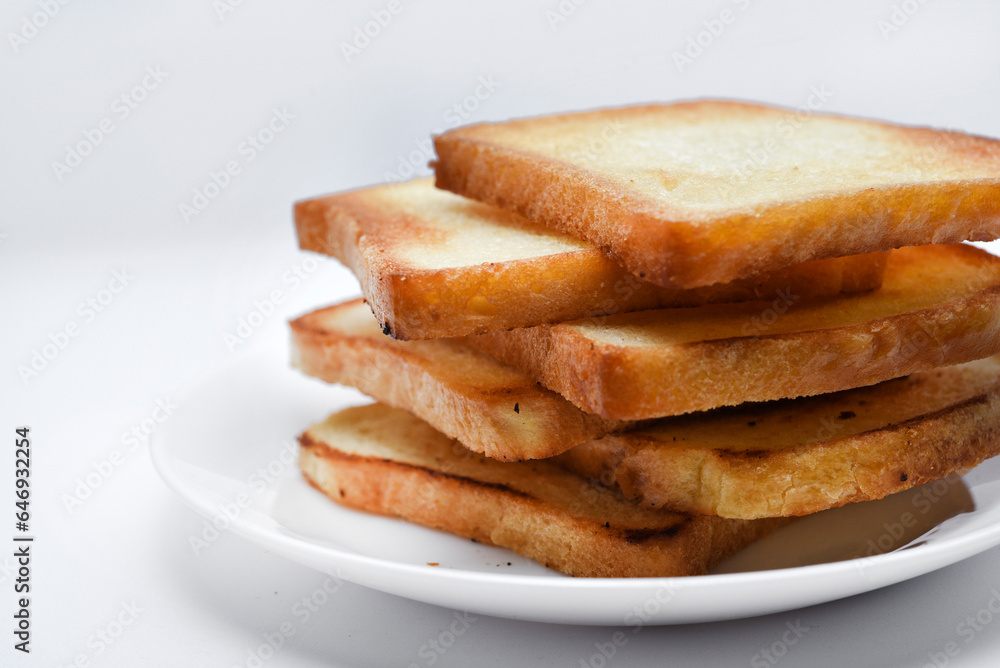 Fried toast on a white plate. Baked bread for sandwiches. Vegan food. Fried toast on a white plate. Baked bread for sandwiches. Vegan food.