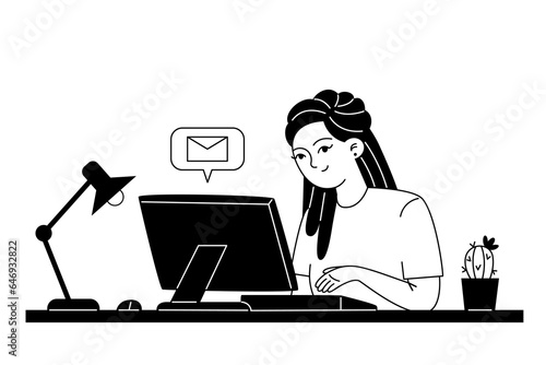 Young female employee corresponds by email while sitting at a computer at her workplace