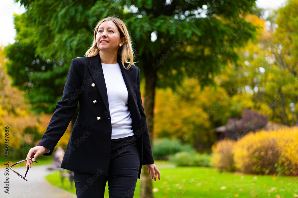 Beautiful businesswoman walking in city park
Beautiful businesswoman walking in city park