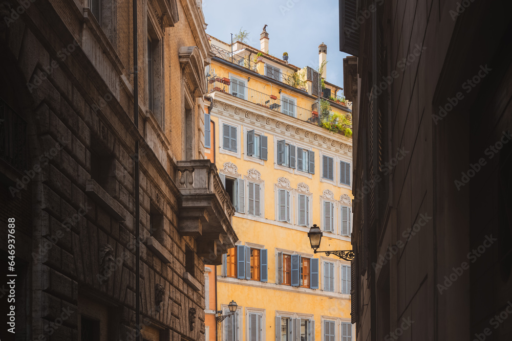 Traditional and colourful residential buildings and architecture in Rione VI Parione in central old town of historic Rome, Italy.