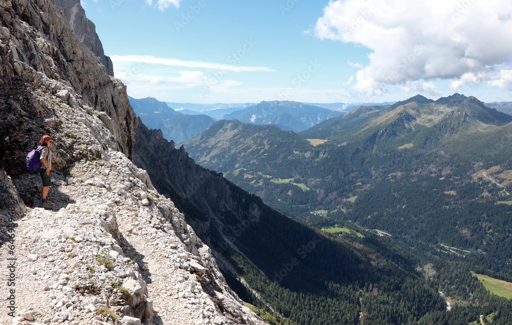 Fototapeta premium trail in the European alps in Northern Italy in summer and young female hiker