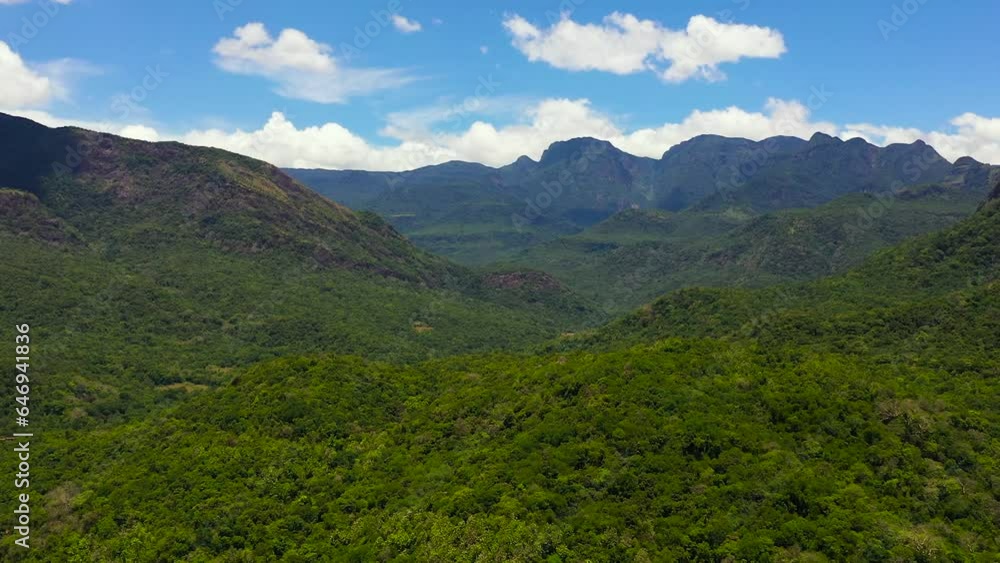 Top view of mountains covered rainforest, trees and blue sky with clouds. Sri Lanka. Top view of mountains covered rainforest, trees and blue sky with clouds. Sri Lanka.