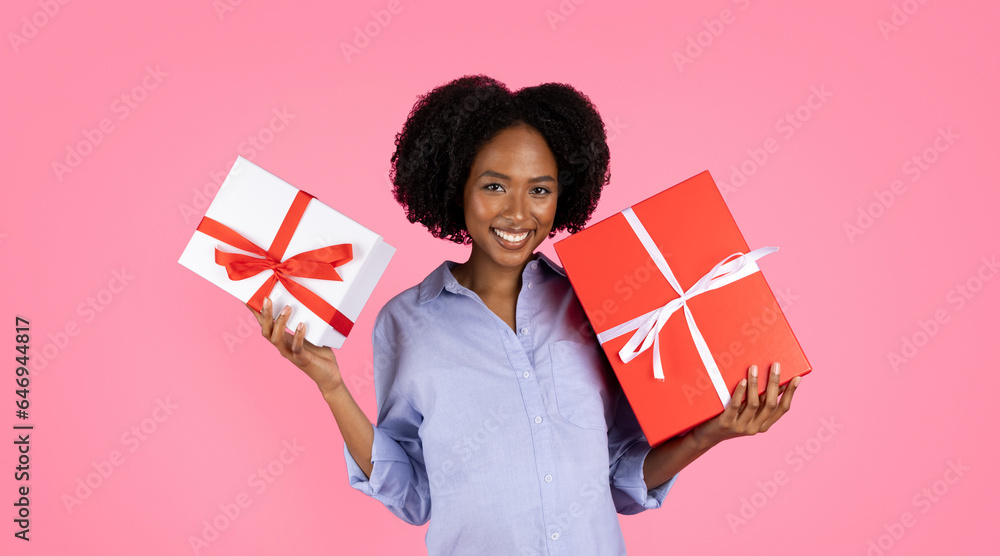 Happy millennial black lady shows boxes with presents, enjoy celebrate party of unborn child Happy millennial black lady shows boxes with presents, enjoy celebrate party of unborn child