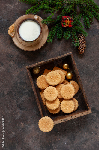 Christmas background with a cup of milk and homemade cookies for Santa Claus