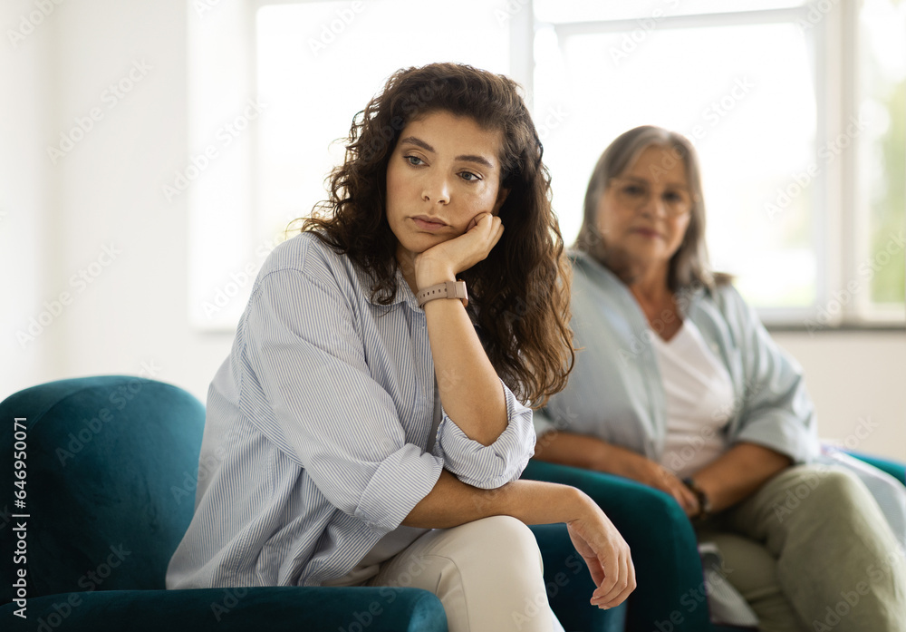 Upset offended unhappy caucasian adult woman ignores old mom, has stress, depression at quarrel Upset offended unhappy caucasian adult woman ignores old mom, has stress, depression at quarrel