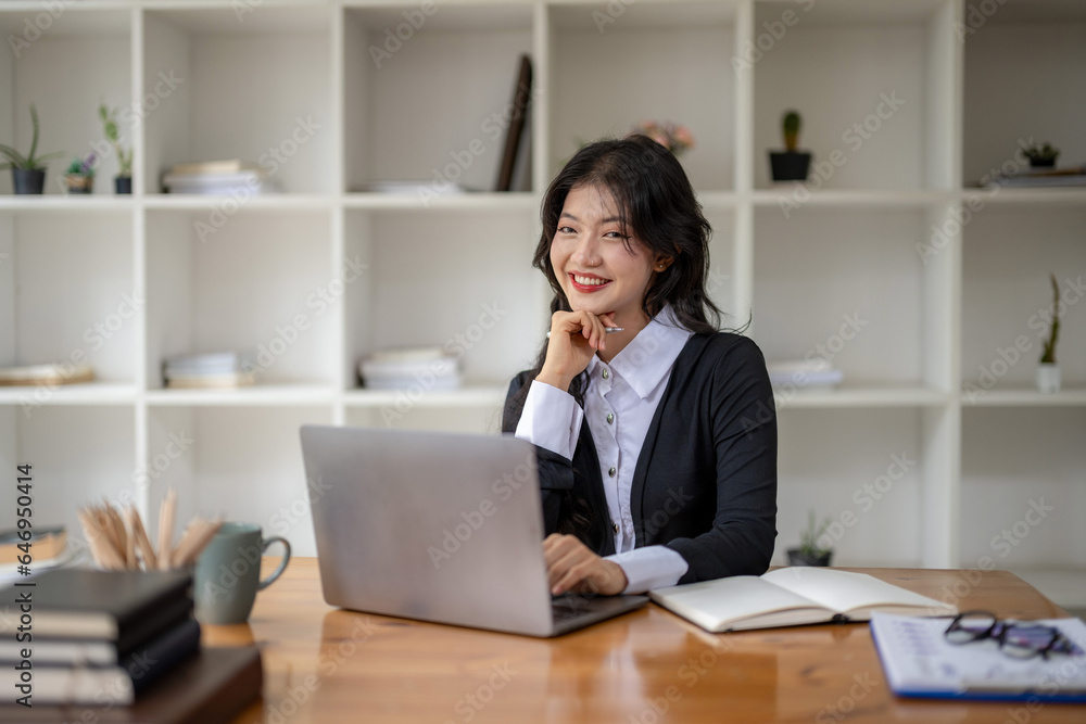 Young businesswoman working on laptop. Think and analyze data and plan work. Young businesswoman working on laptop. Think and analyze data and plan work.