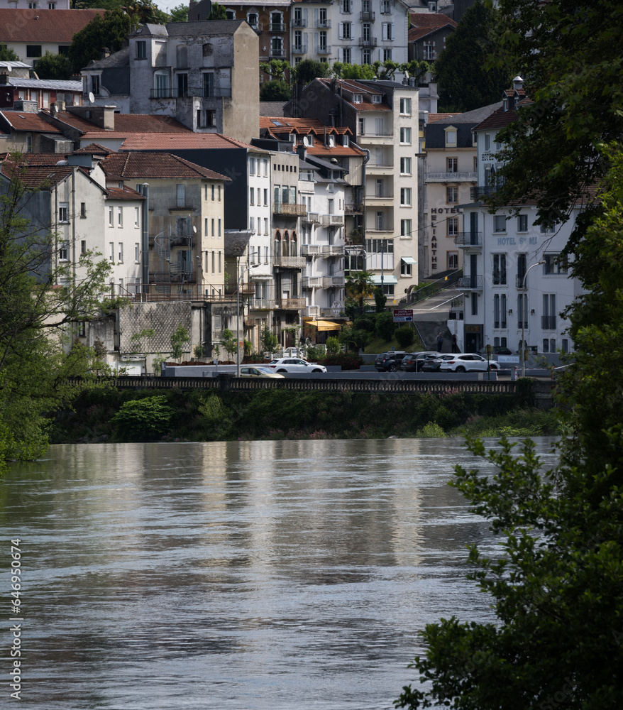 Obraz premium View across the Gave de Pau river to the town of Lourdes