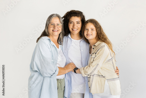 Cheerful caucasian pretty senior, mature and young women in casual holding hands, hugs