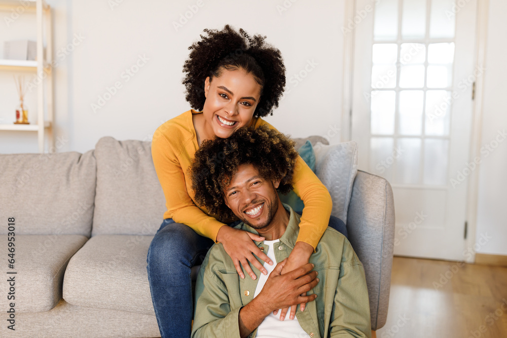 Happy African American Couple Sharing Warm Embrace on Sofa Indoor Happy African American Couple Sharing Warm Embrace on Sofa Indoor