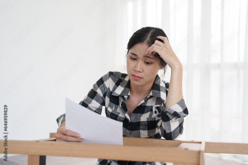 Woman sitting read manual for assemble furniture at new house. Woman sitting read manual for assemble furniture at new house.