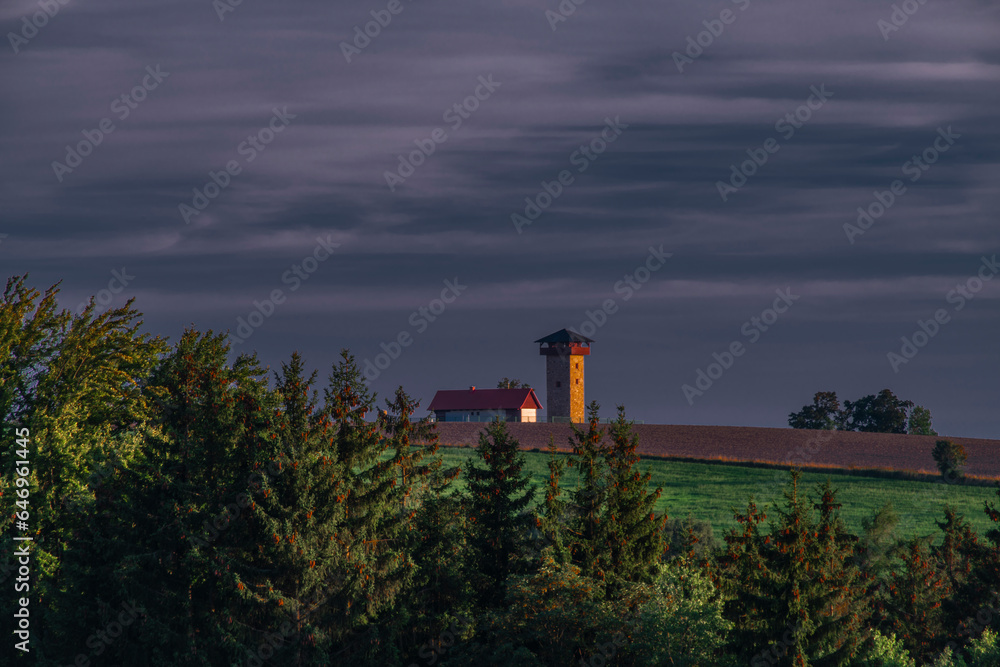 Lookout tower on hill near Roprachtice village in color evening Lookout tower on hill near Roprachtice village in color evening
