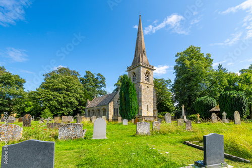 The Parish Church of Saint Mary Lower Slaughter rises above the historic cemetery on it's grounds at the picturesque Cotswold village of Lower, Slaughter, England UK.