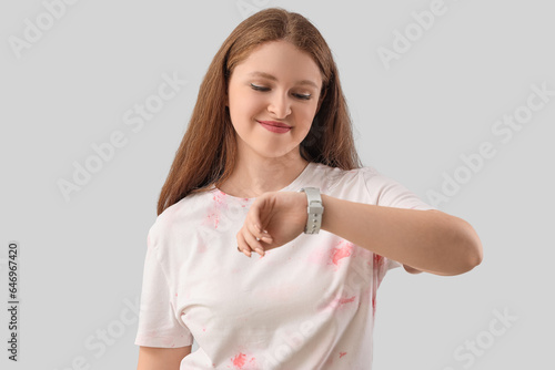 Young woman looking at wris...