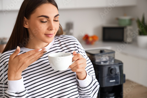 Young woman with cup of hot...