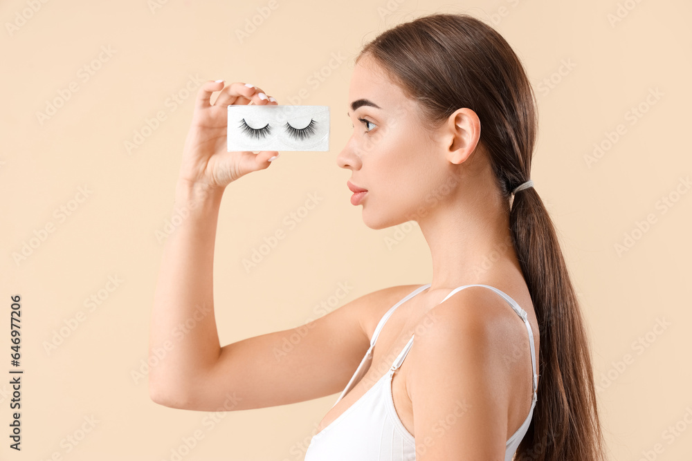 Young woman with false eyelashes on light background Young woman with false eyelashes on light background