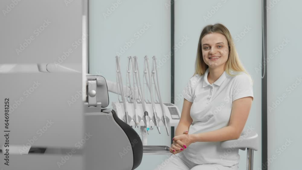 Dentist sitting and looking at camera. The dental clinic operates on modern equipment, which allows us to ensure the best results and satisfy clients with results and comfort Dentist sitting and looking at camera. The dental clinic operates on modern equipment, which allows us to ensure the best results and satisfy clients with results and comfort