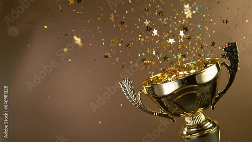 Wallpaper Mural Super Slow Motion. Champion Golden Trophy with Exploding Gold Glitters and Stars against black background. Concept of Success, Victory or Achievement. Torontodigital.ca