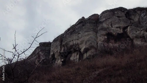 Large rock formation on a hill in winter, large boulder of rock in Central Europe