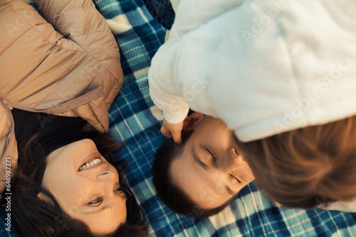 Autumn's glow highlights family’s picnic affection moments photo