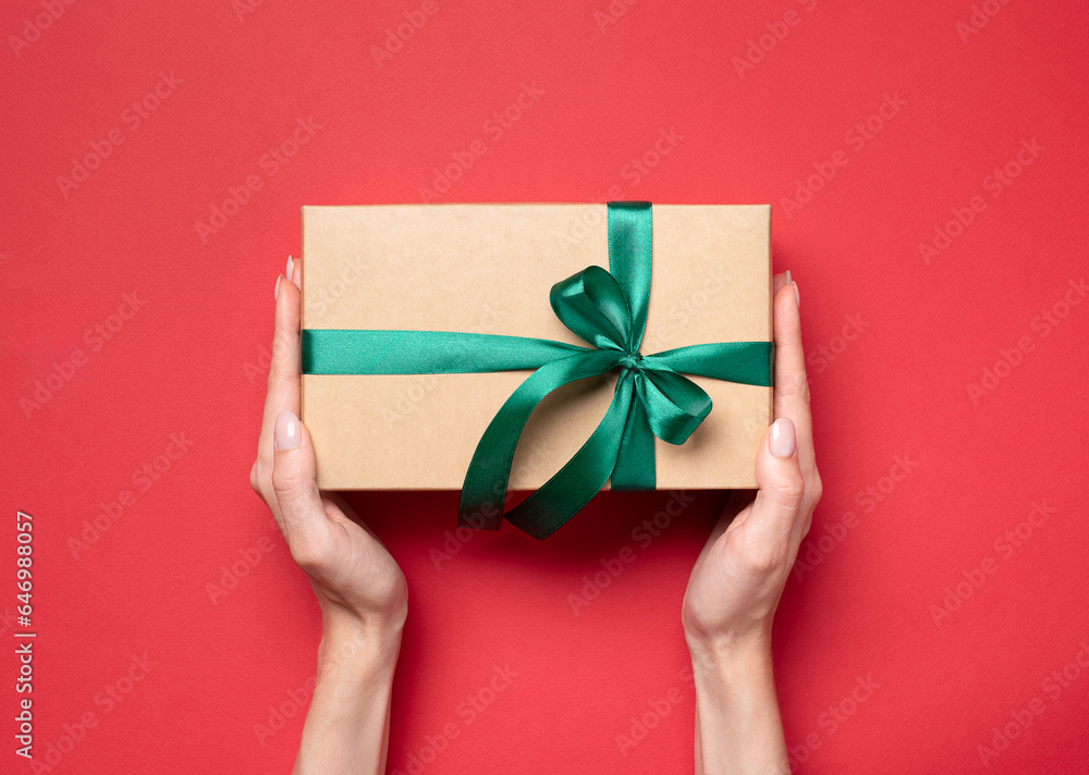 gift box in hands on a red background gift box in hands on a red background