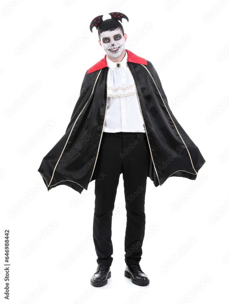 Young man dressed for Halloween as vampire on white background