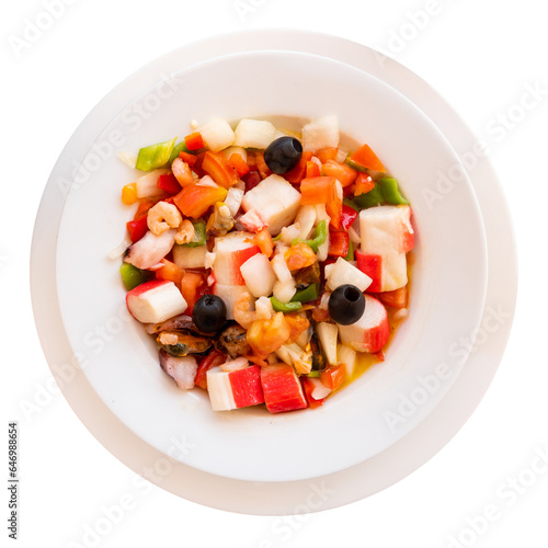 Fresh salad with seafood and vegetables served on dish in restaurant. Isolated over white background