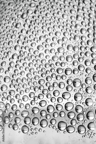 water drops on the transparent surface of a glass bottle , condensation
