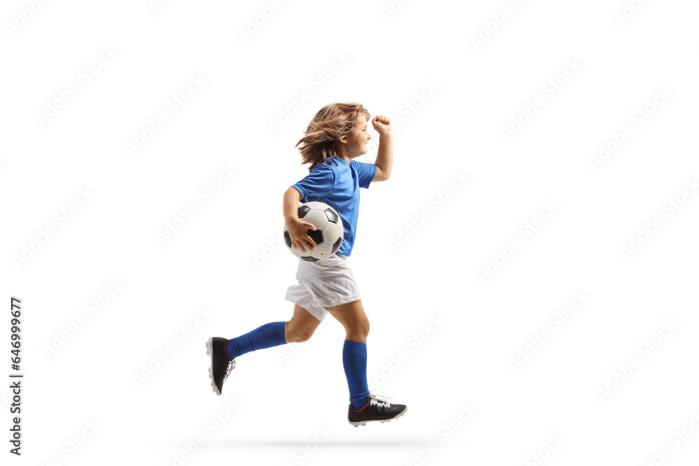 Full length profile shot of a girl in a football kit running with a ball Full length profile shot of a girl in a football kit running with a ball