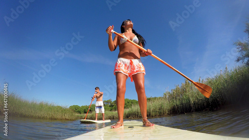Woman stand up paddleboarding © homydesign