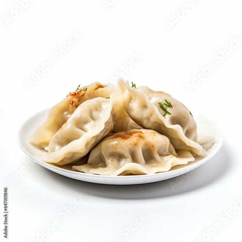 Delicious dumplings covered in savory sauce on a white plate