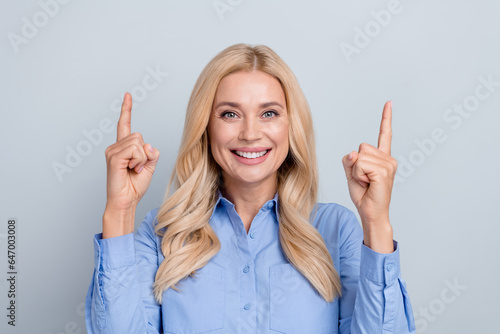 Photo of gorgeous blond woman directing index fingers up empty space ad ads adv wear office shirt isolated grey color background