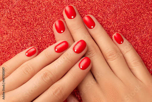 Close up womans hands with red minimalist nail design. Manicure, pedicure beauty salon concept