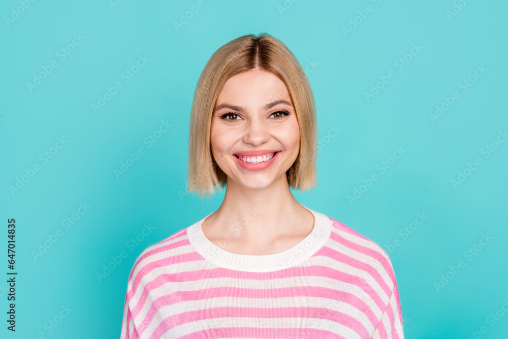 Photo of cheerful positive girl dressed striped sweater smiling showing white teeth isolated teal color background Photo of cheerful positive girl dressed striped sweater smiling showing white teeth isolated teal color background