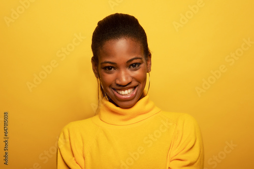 Charming fashionable young black woman 20s wears yellow sweater