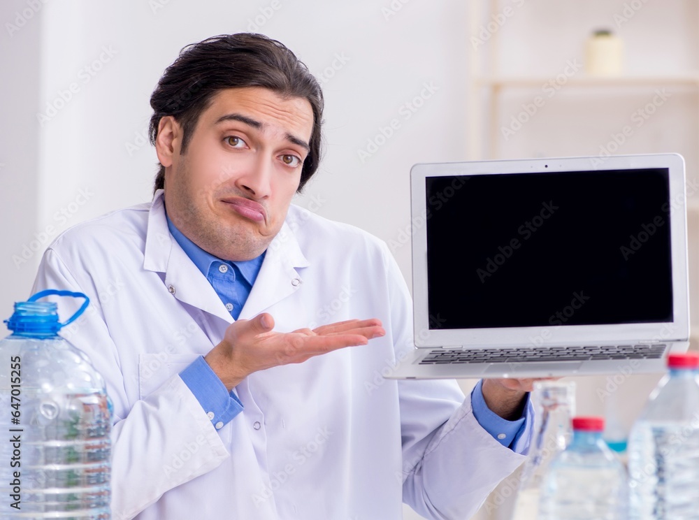 Young male chemist experimenting in lab Young male chemist experimenting in lab