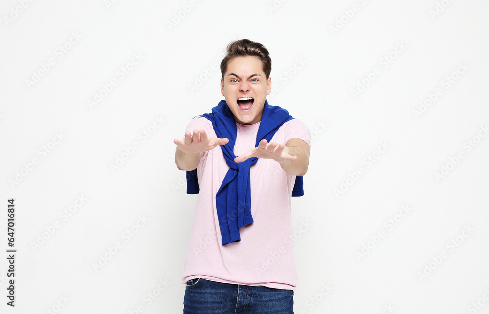 young man celebrating victory over white background young man celebrating victory over white background