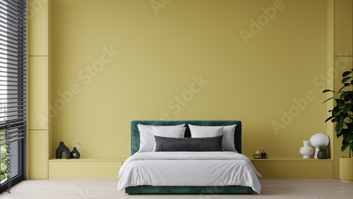 Bright yellow mustard bedroom with a dark green emerald bed. Horizontal large background for art or wallpaper. Mockup for a picture. Ocher color paint wall modern minimal interior design. 3d render