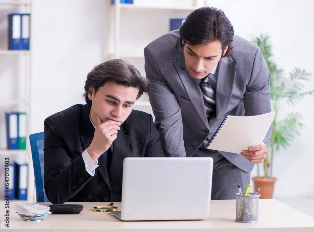 Two young employees working in the office Two young employees working in the office