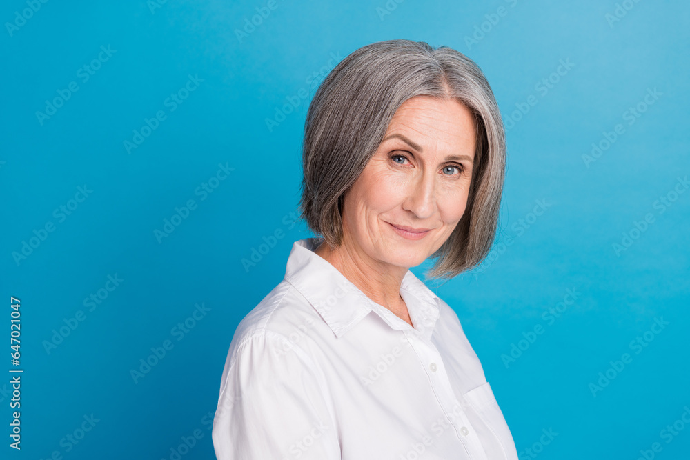 Profile portrait of satisfied company chief director lady empty space blank isolated on blue color background Profile portrait of satisfied company chief director lady empty space blank isolated on blue color background