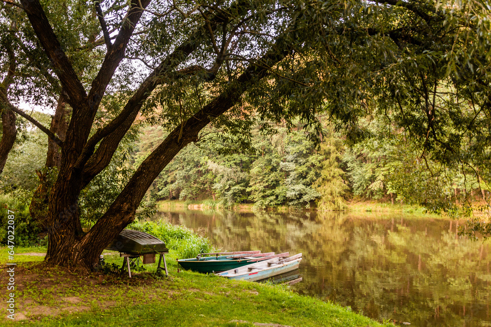 Fototapeta premium Evening view of boats at Luznice river, Czech Republic