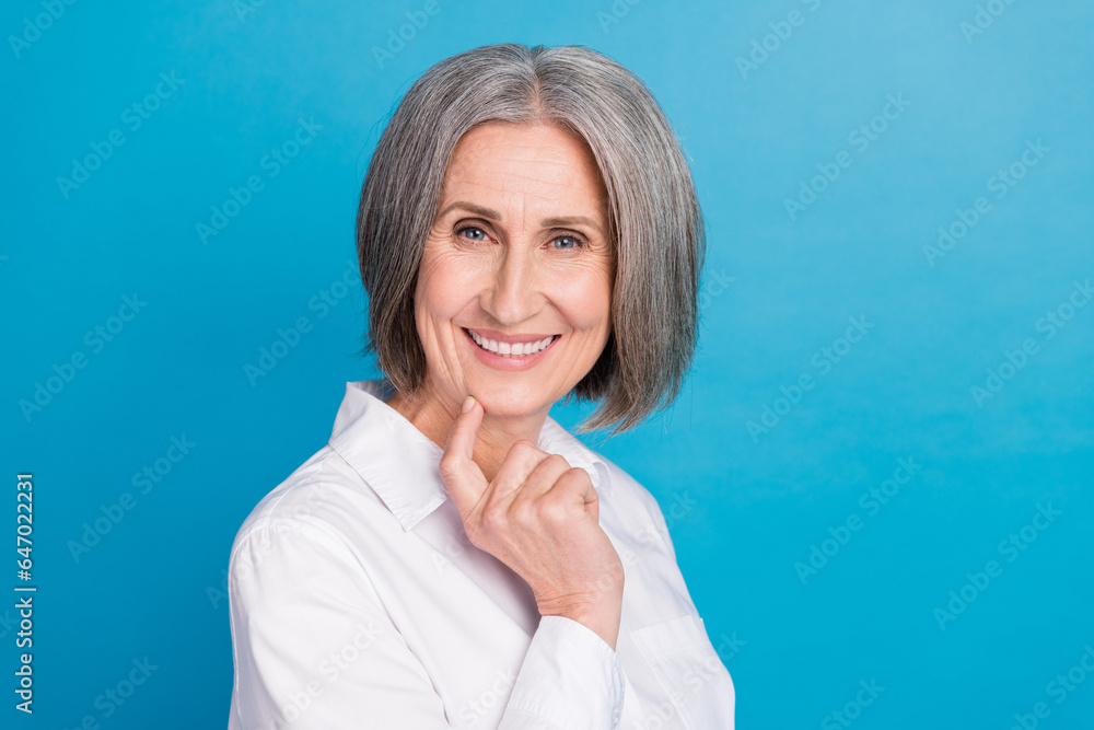 Profile portrait of smart creative person toothy smile finger touch chin empty space isolated on blue color background Profile portrait of smart creative person toothy smile finger touch chin empty space isolated on blue color background