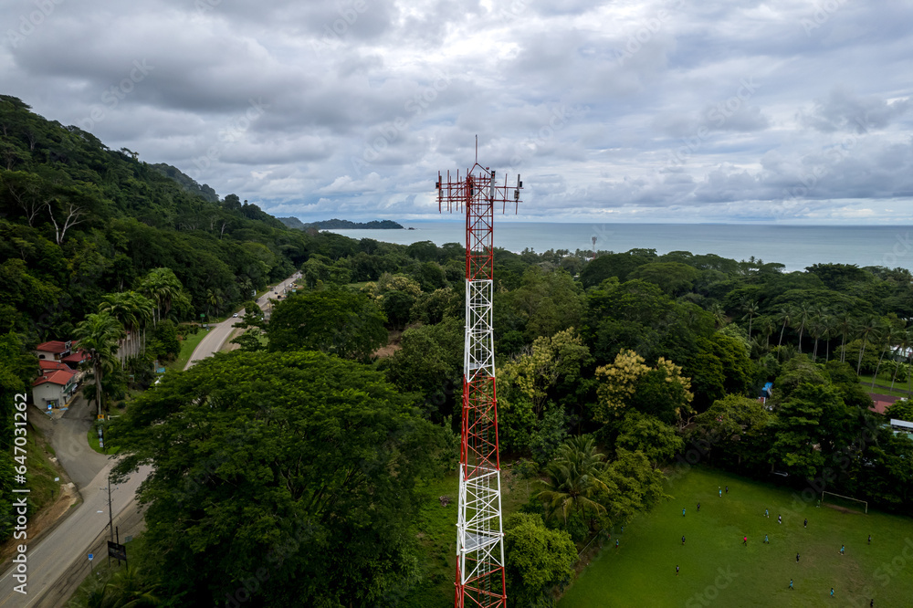 Close up aerial footage of a Cellular, telecommunications, g5 tower in the Mountain and beach of Costa Rica