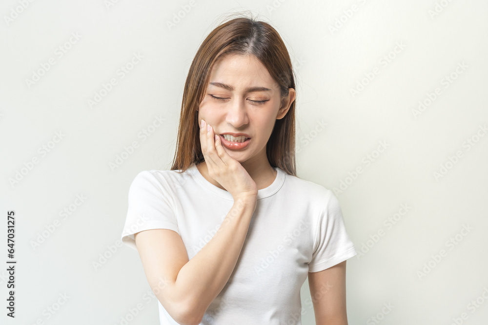 Face expression suffering from sensitive teeth and cold, asian young woman, girl feeling hurt, pain touching cheek, mouth with hand. Toothache molar tooth, dental problem isolated on white background. Face expression suffering from sensitive teeth and cold, asian young woman, girl feeling hurt, pain touching cheek, mouth with hand. Toothache molar tooth, dental problem isolated on white background.