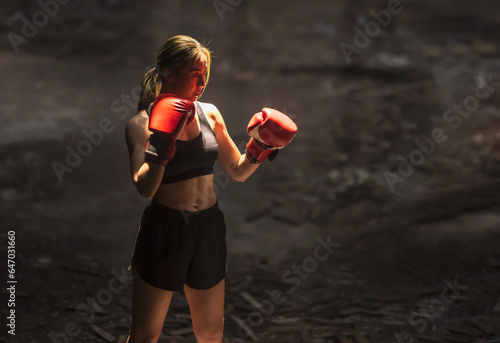 Thai boxing woman with boxing gloves preparing to fight © Jack Tamrong