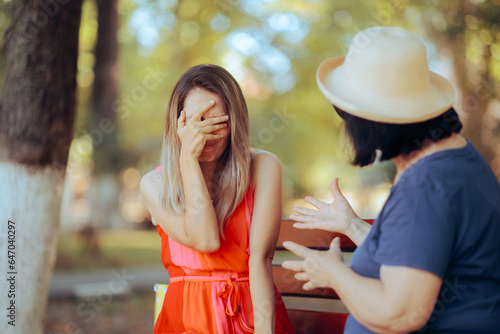 Daughter Feeling Guilty Receiving Critics from her Own Mother. Elderly mom scolding her daughter for a little mistake she made 
 photo