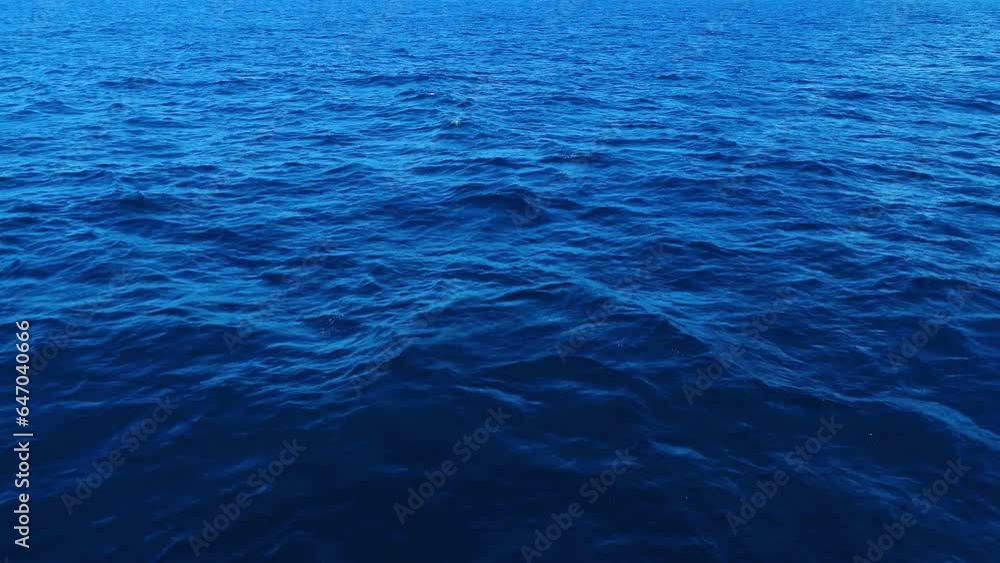 Static bird's eye view of gentle whitecap waves pulsing across ocean pattern texture of deep blue peaks Static bird's eye view of gentle whitecap waves pulsing across ocean pattern texture of deep blue peaks